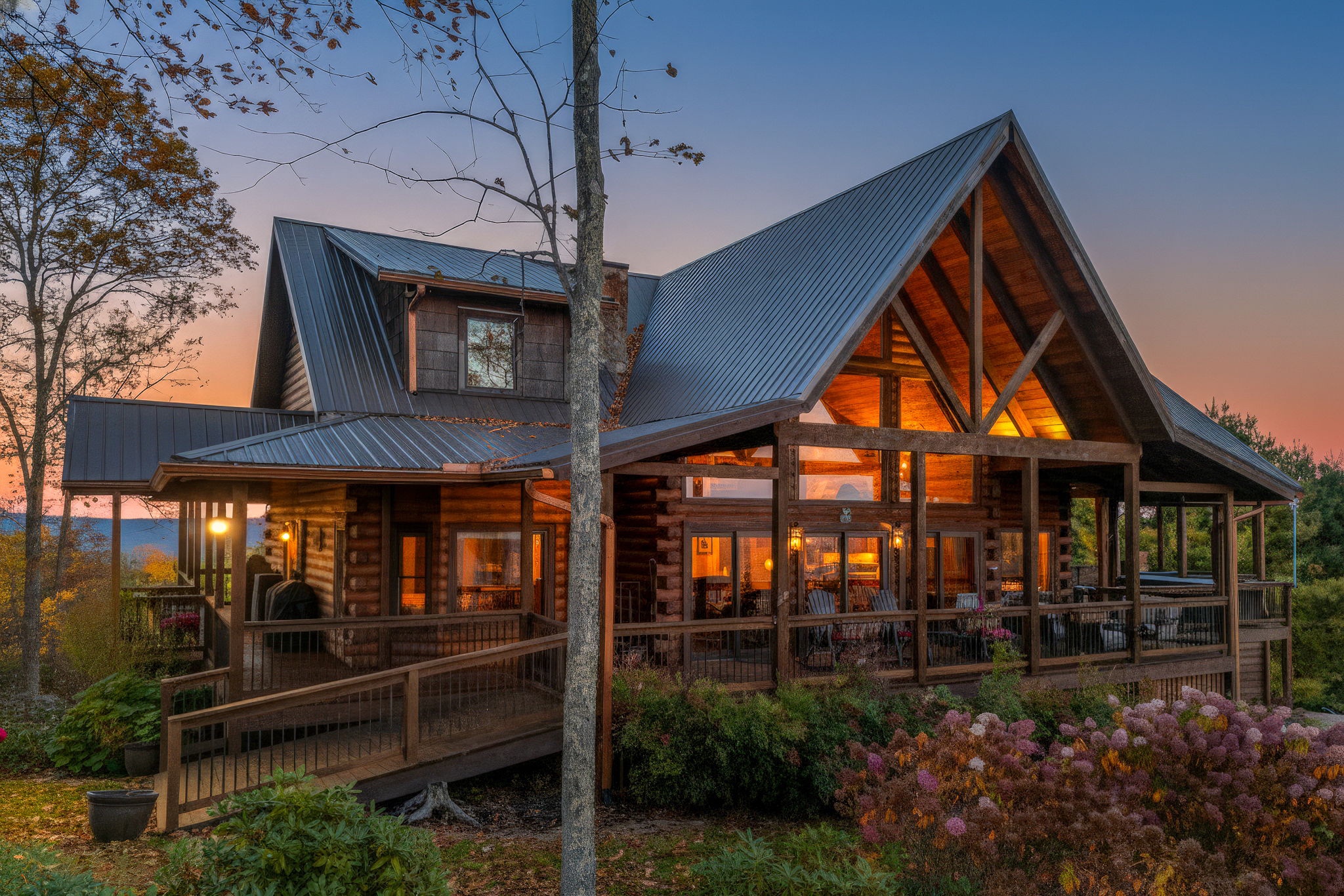 Warm twilight exterior of a luxury log home